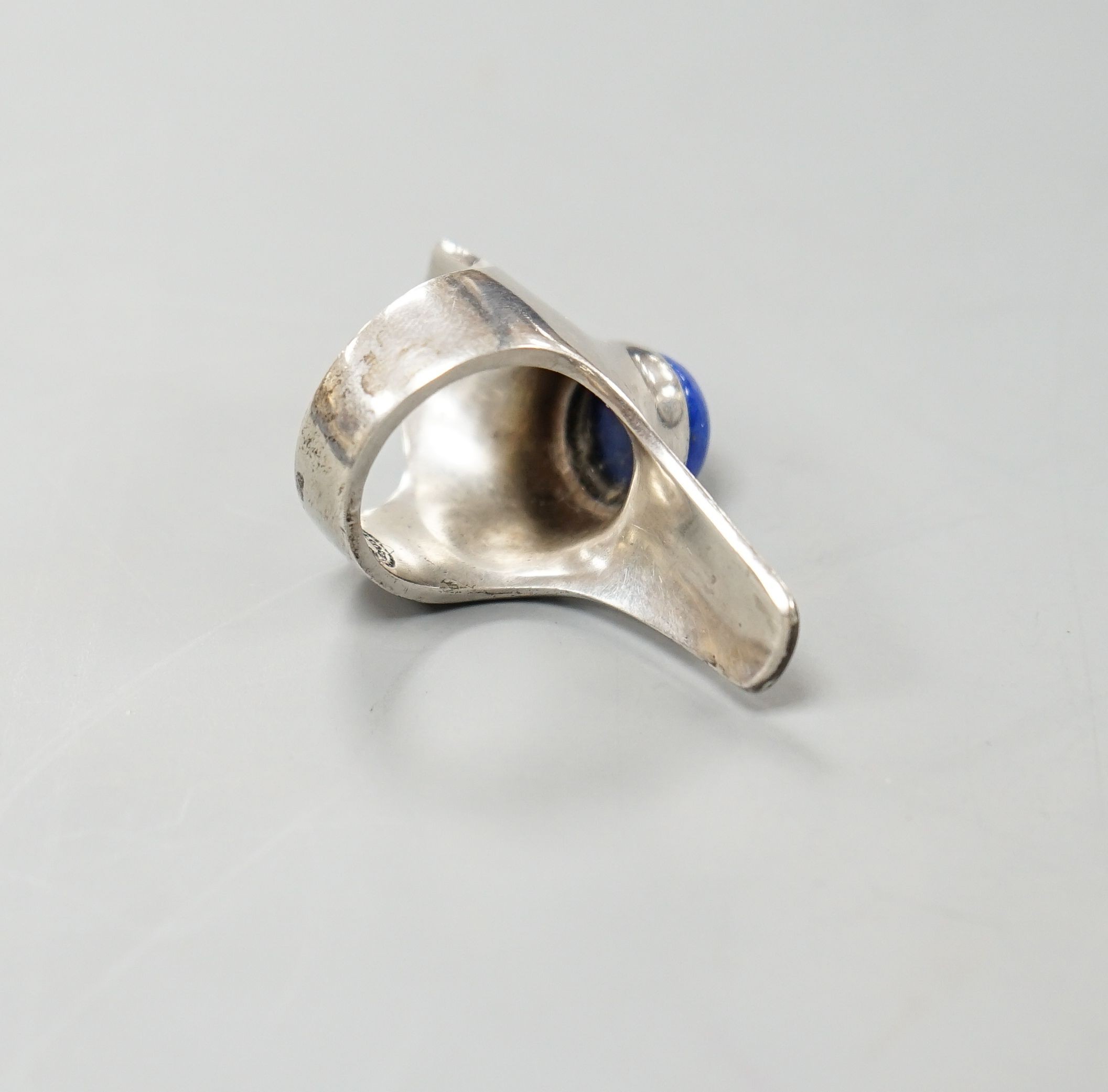 A Georg Jensen sterling and lapis lazuli set upfinger ring, no. 154, size K/L.